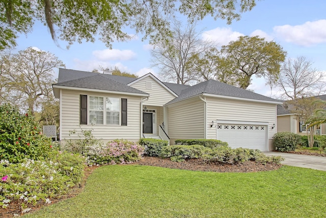 single story home featuring a garage, roof with shingles, a front yard, and concrete driveway