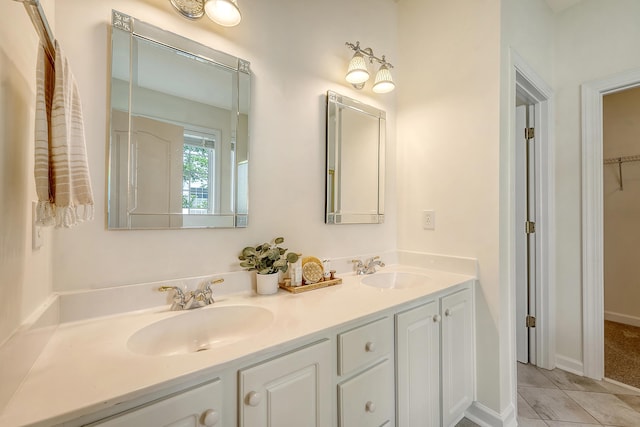 bathroom featuring double vanity, tile patterned floors, and a sink