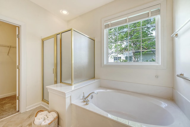 full bath with tile patterned flooring, a spacious closet, a shower stall, and a bath