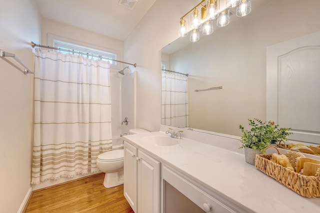 full bathroom with vanity, toilet, wood finished floors, shower / tub combo, and visible vents