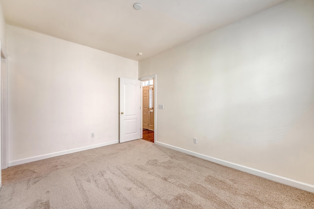 empty room with carpet floors and baseboards