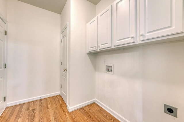 laundry area featuring washer hookup, electric dryer hookup, cabinet space, baseboards, and light wood finished floors