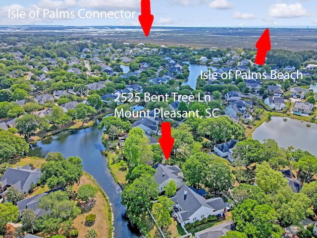 drone / aerial view featuring a water view and a residential view