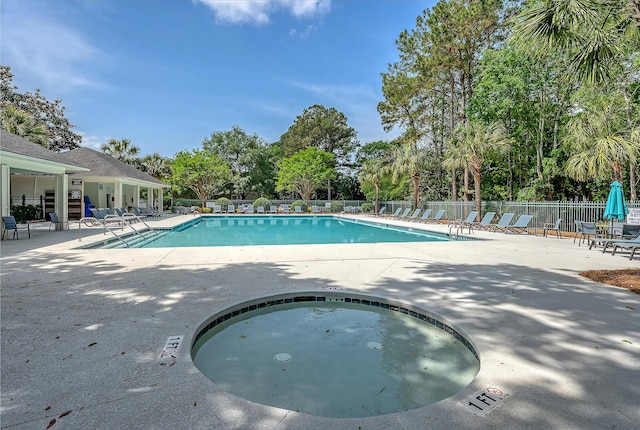 pool with fence and a patio area