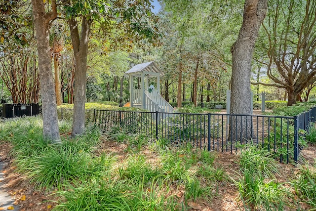 view of yard with fence and a playground