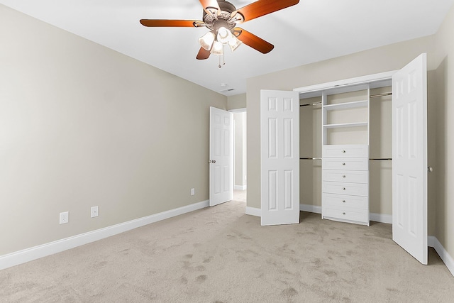 unfurnished bedroom featuring light colored carpet, baseboards, a closet, and ceiling fan