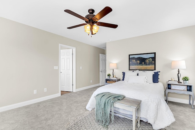 bedroom featuring light carpet, ceiling fan, and baseboards