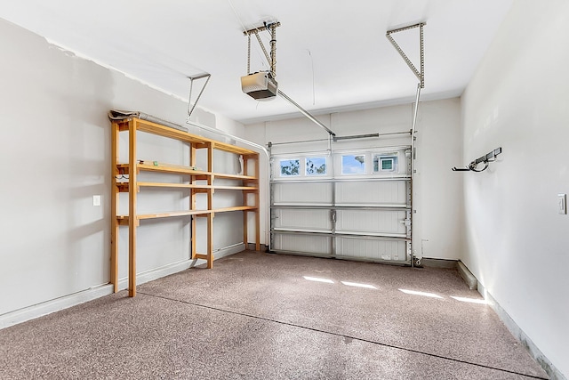 garage featuring a garage door opener and baseboards