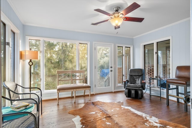 sunroom / solarium featuring ceiling fan