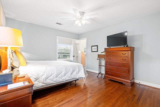 bedroom with visible vents, ceiling fan, baseboards, and wood finished floors