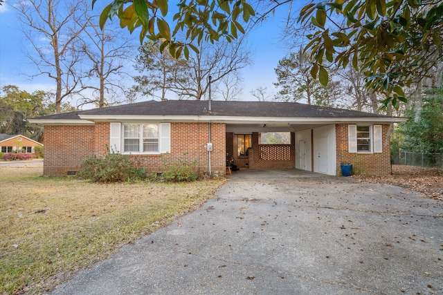 ranch-style house with brick siding, concrete driveway, a front yard, crawl space, and an attached carport