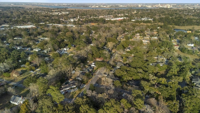 birds eye view of property featuring a forest view