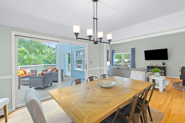 dining room with a notable chandelier and light wood-type flooring