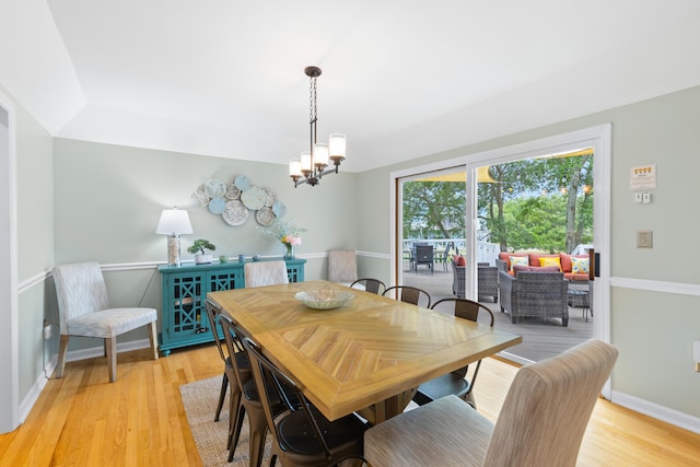 dining space with a notable chandelier and light hardwood / wood-style floors