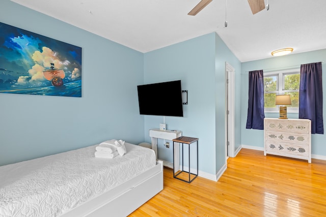 bedroom with light hardwood / wood-style flooring and ceiling fan