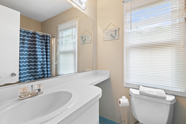 bathroom featuring toilet and vanity