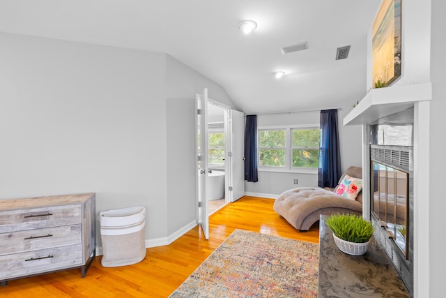 bedroom featuring lofted ceiling and light hardwood / wood-style floors