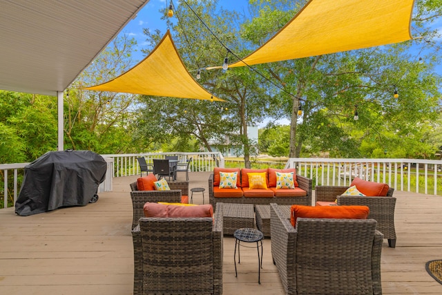 wooden deck featuring an outdoor living space and a grill