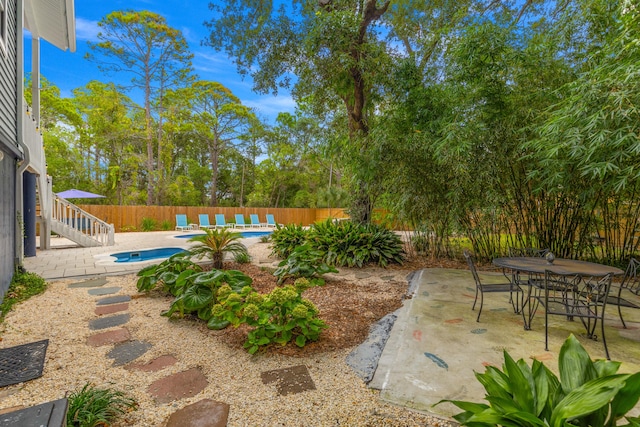 view of yard featuring a fenced in pool and a patio area