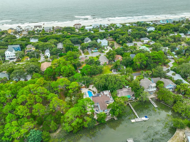 drone / aerial view featuring a beach view and a water view