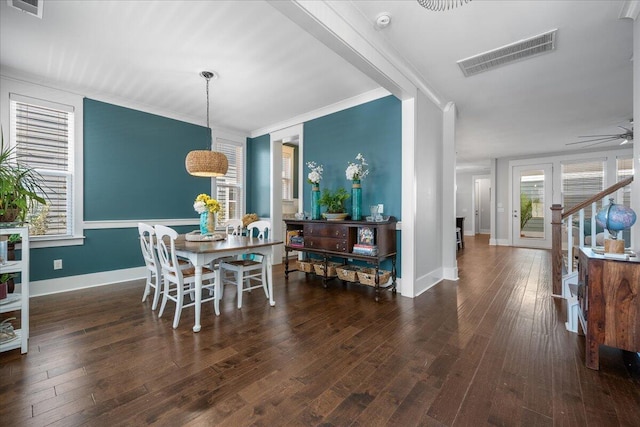 dining room with dark hardwood / wood-style flooring, ornamental molding, and ceiling fan