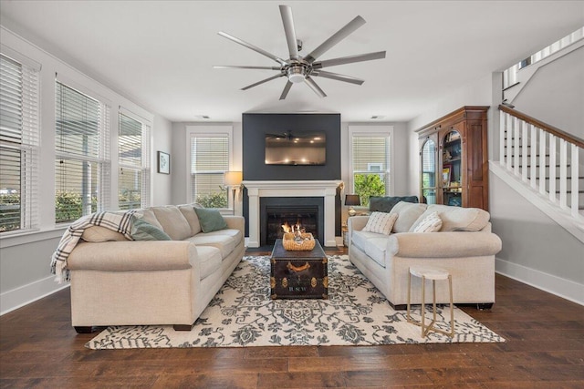 living room with dark wood-type flooring and ceiling fan