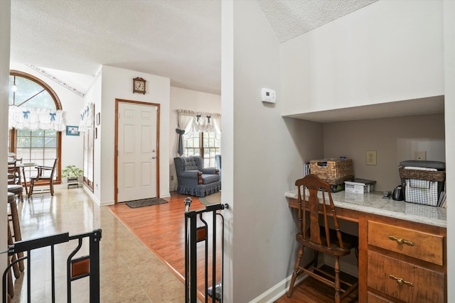 8661 Laurel Grove Ln, North Charleston, SC 29420 - interior space with built in study area, baseboards, a textured ceiling, and lofted ceiling