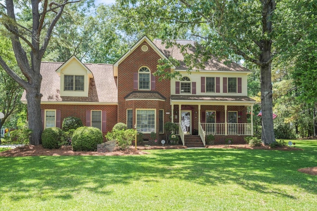 8661 Laurel Grove Ln, North Charleston, SC 29420 - view of front of property with brick siding, a shingled roof, a front lawn, and covered porch