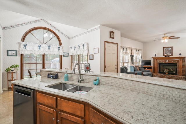 8661 Laurel Grove Ln, North Charleston, SC 29420 - kitchen featuring a ceiling fan, light stone countertops, dishwasher, a sink, and open floor plan