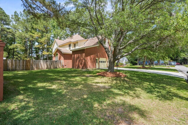 8661 Laurel Grove Ln, North Charleston, SC 29420 - view of property exterior with brick siding, fence, a yard, and driveway