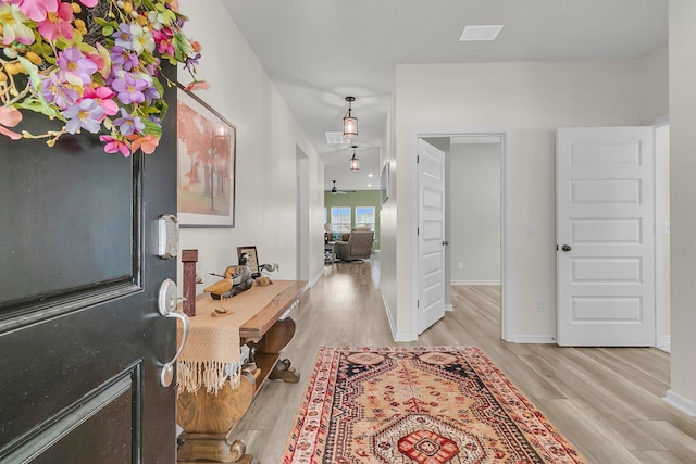 entryway featuring light wood-style flooring and baseboards