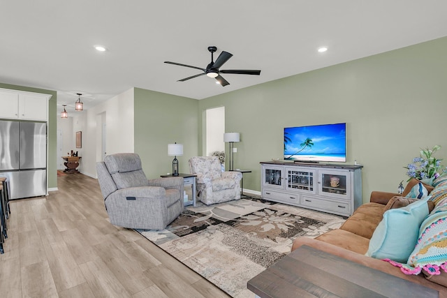 living area featuring ceiling fan, light wood-type flooring, baseboards, and recessed lighting