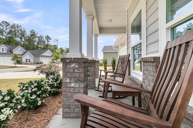 view of patio / terrace featuring a porch and a residential view