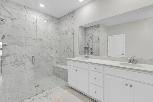 bathroom featuring marble look tiles, a marble finish shower, recessed lighting, and double vanity