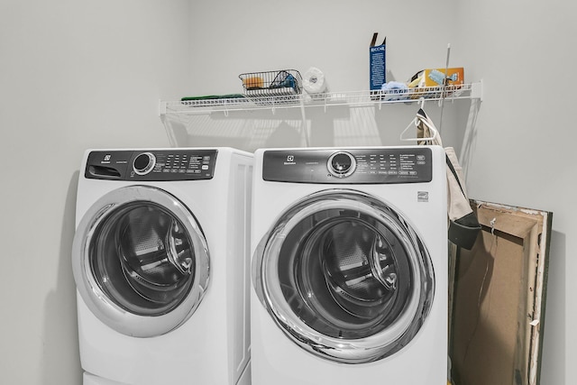laundry room featuring washing machine and clothes dryer