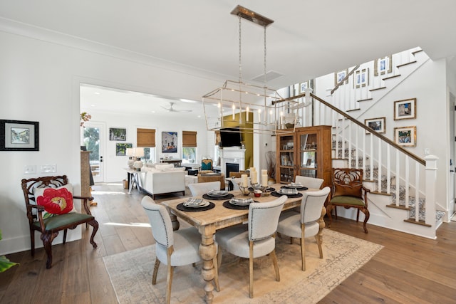 dining space featuring hardwood / wood-style floors, ceiling fan, and crown molding