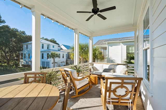 sunroom / solarium featuring ceiling fan