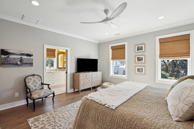 bedroom with multiple windows, dark hardwood / wood-style floors, ceiling fan, and ensuite bathroom