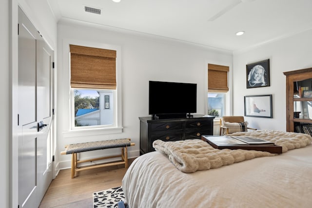 bedroom featuring crown molding, ceiling fan, and wood-type flooring