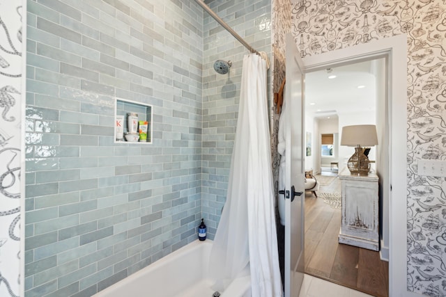 bathroom with shower / bathtub combination with curtain and wood-type flooring