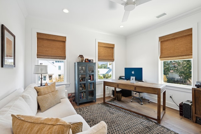 home office with plenty of natural light, ceiling fan, wood-type flooring, and ornamental molding