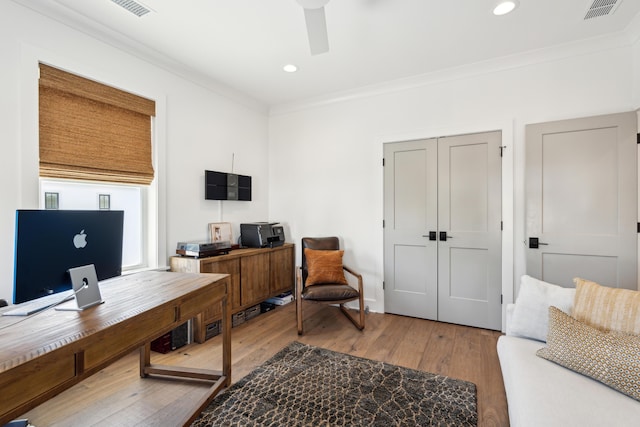 home office featuring hardwood / wood-style floors and ornamental molding