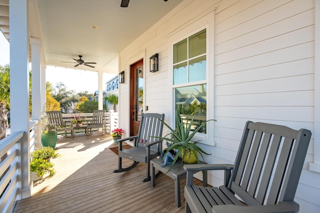 wooden deck featuring ceiling fan