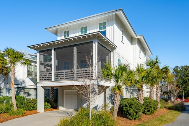 view of front of property featuring a sunroom and a garage