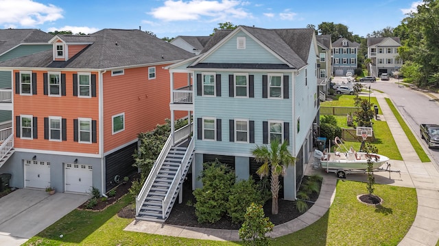 307 Morning Marsh Ln, Charleston, SC 29492 - rear view of property featuring stairway, a garage, a residential view, and driveway