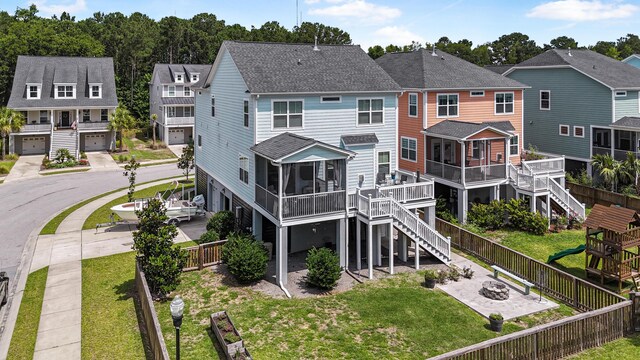 307 Morning Marsh Ln, Charleston, SC 29492 - rear view of house featuring a fenced backyard, roof with shingles, stairway, and a residential view