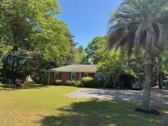 709 N Cedar St, Summerville, SC 29483 - view of front facade featuring a front lawn and driveway