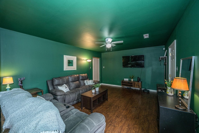 living area featuring ceiling fan, visible vents, baseboards, and wood finished floors