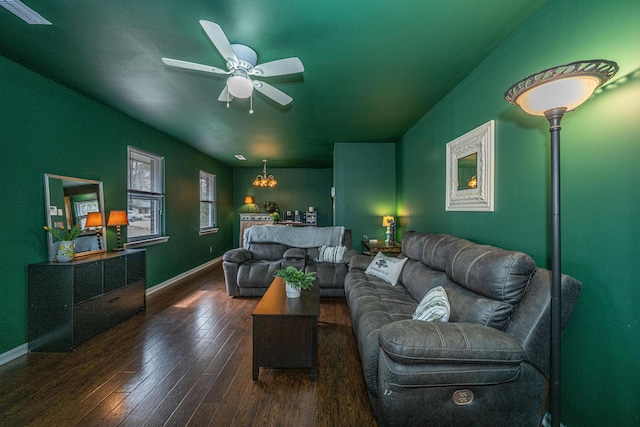 living area with baseboards, wood-type flooring, visible vents, and a ceiling fan