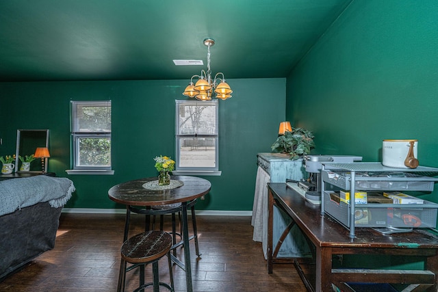 dining area with baseboards, wood-type flooring, visible vents, and a notable chandelier